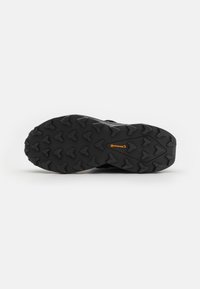 Sort atletisk skosål med udtalt mønster, der har et rundt design og er fremhævet med orange "Continental" branding.