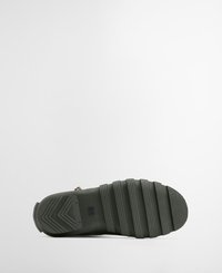 Olive green rubber boot featuring a textured sole with horizontal ridges and a zigzag pattern, designed for traction and durability.