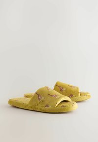 Yellow plush slippers featuring a giraffe print, open toe design, and soft texture, suitable for indoor use.