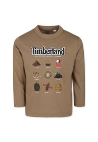 Brązowy t-shirt z długim rękawem z graficznym nadrukiem przedstawiającym ikony związane z naturą oraz napisem "Timberland" umieszczonym na górze.