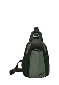 Tummanvihreä olkalaukku, jonka muoto on kolmio, ja jossa on teksturoituja kuusikulmaisia yksityiskohtia, säädettävä hihna ja etulokerossa vetoketju.