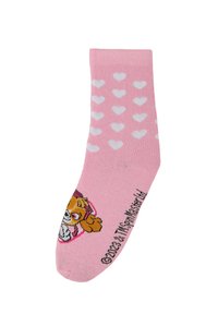 Calzino rosa alla caviglia con motivi a cuore bianchi e una grafica di un cane cartone animato con una fascia rosa e testo nella parte inferiore.