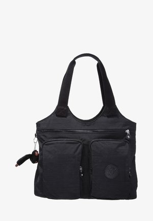 Sac cabas noir avec deux poches avant zippées, des anses larges et un petit porte-clés singe en peluche accroché sur le côté.