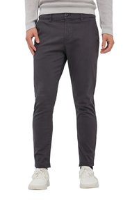 Pantaloni slim-fit grigi in cotone stretch, con un design a vita alta, tasche laterali e chiusura con bottone in vita, abbinati a sneakers bianche.