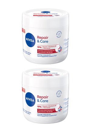 NIVEA Repair & Care Cremedose, weißer Plastikbehälter, runde Form, rote und blaue Akzente, etikettiert mit Zutaten und Anwendungshinweisen in mehreren Sprachen.