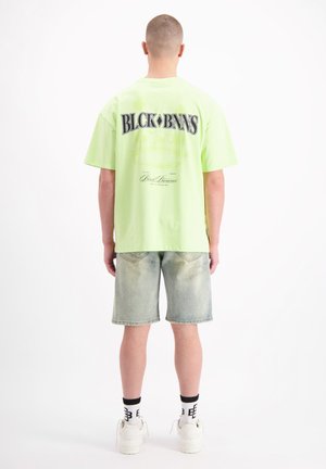 PARADISE - Print T-shirt - yellow