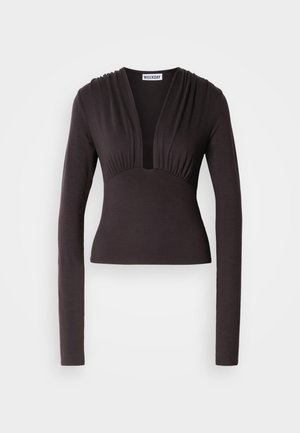 Black long-sleeve top with a deep V-neck and gathered detailing at the shoulder, made from soft fabric, fitted at the waist.
