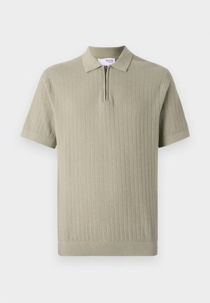 Stickad polo shorts i ljusgrön, med en dragkedja i kragen, korta ärmar och vertikal ribbad textur. Slät bomullsblandning.