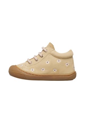 Helle beigefarbene Wildlederschuhe mit runder Zehenform und Gummisohle. Verziert mit gestickten Blumendesigns und beigefarbenen Schnürsenkeln. Kurze Knöchelhöhe.