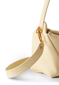 Cream-colored synthetic handbag with a textured finish, featuring a smooth shoulder strap and gold hardware accents.