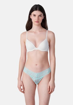 White padded bra with thin straps and a plunge neckline paired with light blue lace thong featuring floral patterns along the waistband.