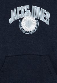 Sudadera azul marino con un gran logo de "JACK & JONES", emblema circular con "DENIM & DREAMS" y un bolsillo tipo canguro en la parte delantera.