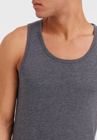 Gray sleeveless tank top made of soft fabric, featuring a rounded neckline and smooth texture, emphasizing a close-fitting design.