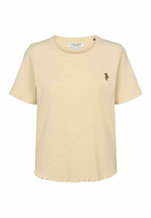 Kratke rukave, rebrasta rumena majica s okruglim izrezom i valovitim rubom. Ima mali vezeni logotip na lijevoj strani grudi.