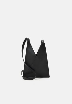 Zwarte leren crossbody tas met een uniek V-vormig ontwerp, een soepele textuur en een enkele verstelbare schouderband. Minimalistische en strakke uitstraling.