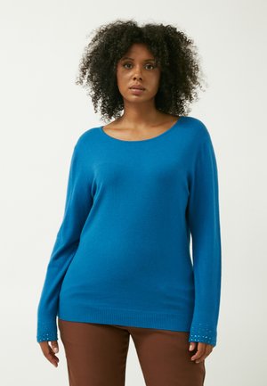 Blauer Langarmpullover mit weitem Ausschnitt und geripptem Saum. Die Bündchen verfügen über dekorative Verzierungen. Weiches Textil.