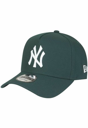 Green baseball cap with a white embroidered "NY" logo on the front, featuring a curved visor and a circular sticker on the brim.