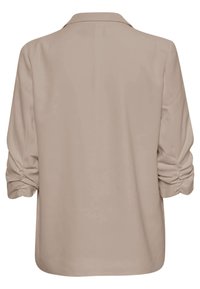 Chemise beige à manches longues avec des détails froncés sur les manches et un col classique, vue de dos.
