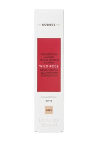 Caja blanca con un panel rojo que presenta "Wild Rose Brightening Foundation", SPF 15. Contiene 30 mL, con acentos dorados y código de producto WRF3.