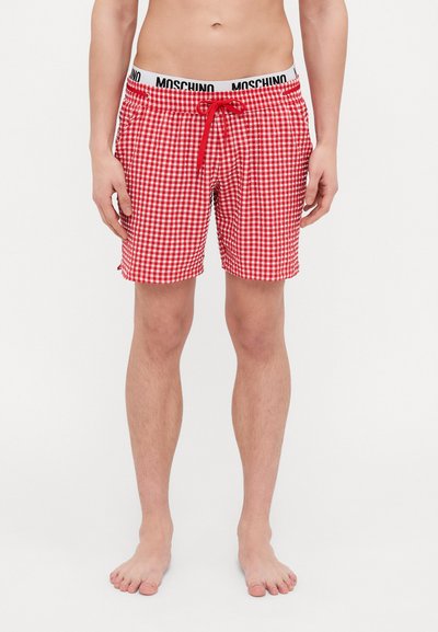 Costume de baie în carouri roșii și albe, cu talie elastică, având un logo Moschino negru, șnur de strângere și cusături laterale.