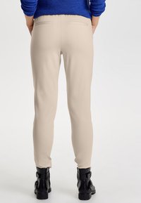 ONLY ONLPOPTRASH LIFE EASY COL - Tracksuit bottoms - beige