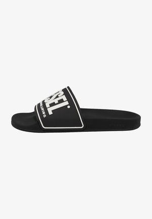 Black slide sandal made of rubber with a wide strap featuring white "DIESEL" logo and contrasting trim. Flat sole for casual wear.