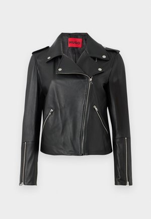 Black leather motorcycle jacket with silver zippers, snap-down collar, and zippered pockets. Features a bold red interior label.