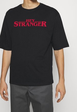 Black short-sleeve t-shirt featuring red text "HEY STRANGER" centered on the front. Classic crew neck design with a relaxed fit.