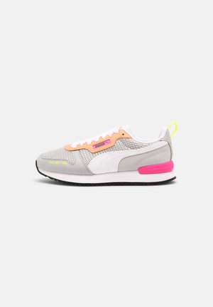 Light gray mesh and suede sneaker with white stripe, peach lace area, neon yellow accents, and pink heel detail, side view on white background.