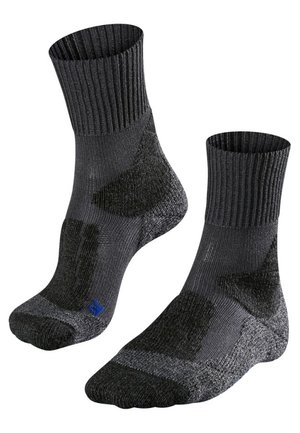 Chaussettes noires avec des bordures côtelées et des zones de talon et d'orteil renforcées. Présentent un logo bleu sur une chaussette. Fabriquées en tissu texturé pour plus de durabilité.