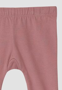 Rosa Leggings aus einem weichen, dehnbaren Stoff. Mit einem elastischen Bund und einer glatten Textur sowie einem figurschmeichelnden Design.