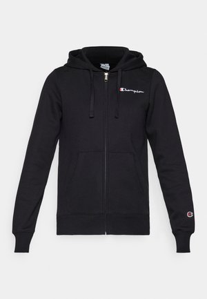 Black zip-up hoodie with a drawstring hood, front pockets, and logo on the left chest. Soft fabric, ribbed cuffs, and hem.