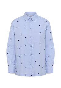 Camicia blu chiaro con bottoni, pattern di cuori navy, colletto, maniche lunghe e taschino sul petto. Realizzata in un tessuto liscio.