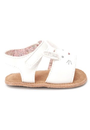 White sandals made of synthetic material with a textured brown sole. Features bunny face design with ears and pink floral lining.