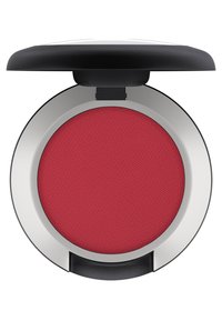 Compact de blush rond avec un dessus noir et une base argentée, contenant une poudre texturée de couleur rouge vif à l'intérieur. Couvercle articulé pour un accès facile.