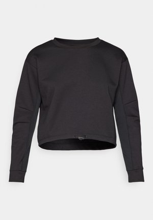Black sweatshirt with a cropped design, long sleeves, round neck, and side panel accents. Made of soft, stretchy material. Adjustable hem drawstring.