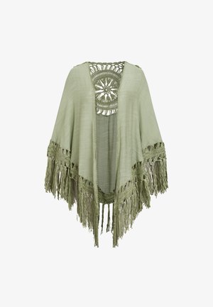 Chal abierto de color verde claro con diseño circular de crochet en la parte trasera y flecos largos a lo largo de los bordes.