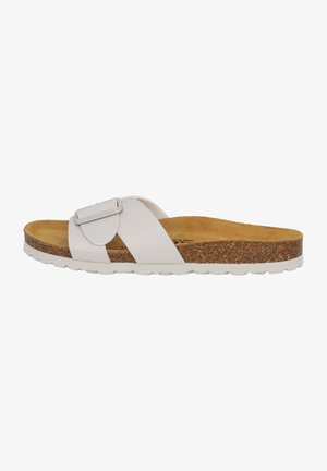 White slide sandal with a wide strap and a metal buckle, featuring a cork footbed and textured rubber sole for grip.