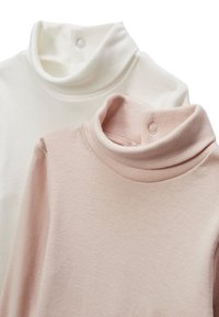 Deux chandails à col roulé : un en blanc, un en rose doux. Tous deux sont en tissu côtelé avec des boutons-pression au cou.