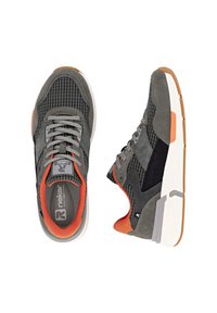 Gray athletic shoes featuring a mix of textures, including smooth and ribbed materials. Accents in orange and black, with white soles and laces.