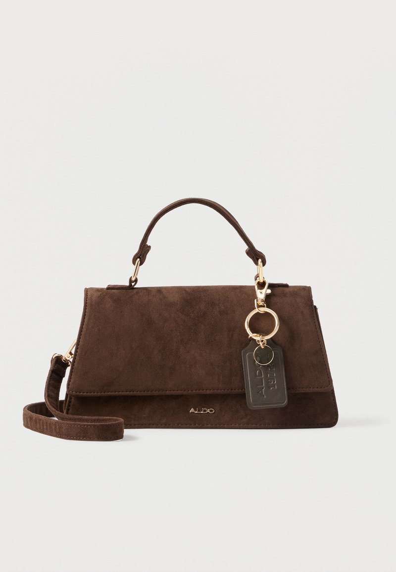 Brown suede handbag with a structured design, gold hardware, and a detachable keychain tag. Features a top handle and adjustable strap.