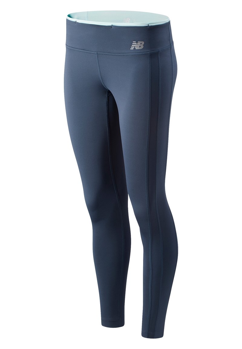 Navy athletic leggings with a high waistband, smooth texture, side seams, and a silver brand logo at the waistband.