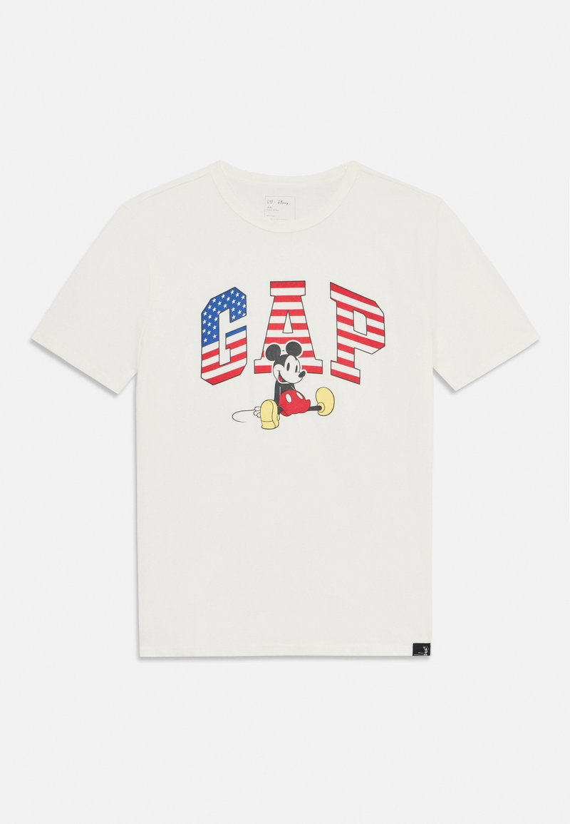 Vit bomulls-T-shirt med stora röda och blå "GAP"-bokstäver, med en grafisk bild av Musse Pigg i mitten, och en liten svart varumärkesetikett.