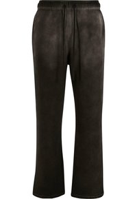 Pantalones de chándal negros con corte relajado, cinturilla elástica con cordón y textura de tela suave. Ideal para el uso casual.
