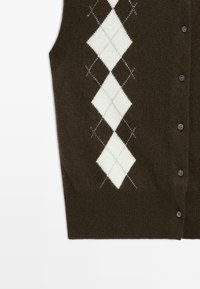 Brown buttoned sleeveless sweater vest with white and gray argyle diamond pattern on the front left side.