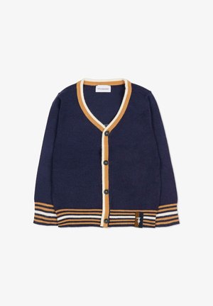 Cardigan navy con scollo a V e chiusura a bottoni, con righe a coste crema e senape su polsini e orlo. Etichetta con logo in basso a sinistra.