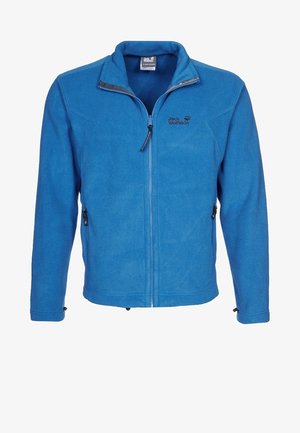 Sininen vetoketjulla varustettu fleece-takki, jossa korkea kaulus ja sivutaskuissa vetoketjut, vasemmassa rinnassa "Jack Wolfskin" -logo.