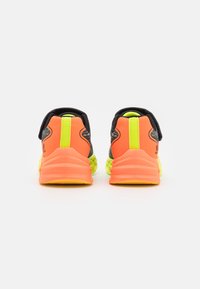 Black, orange, and neon green athletic shoes featuring a textured mesh upper, padded collar, and a thick, cushioned sole.