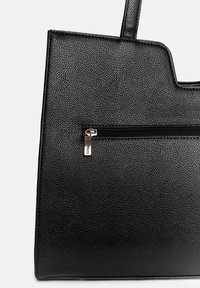 Črna torba iz teksturiranega materiala, ki se ponaša z elegantnim dizajnom, z zadrgo in kovinskimi detajli ter trdnimi ročaji za nošenje.