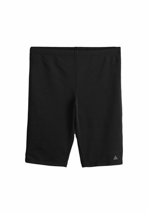 Sorte atletiske knælange shorts med et lille reflekterende trekantet logo på venstre underben.